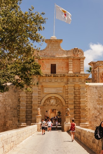 A group of people walking across a bridge