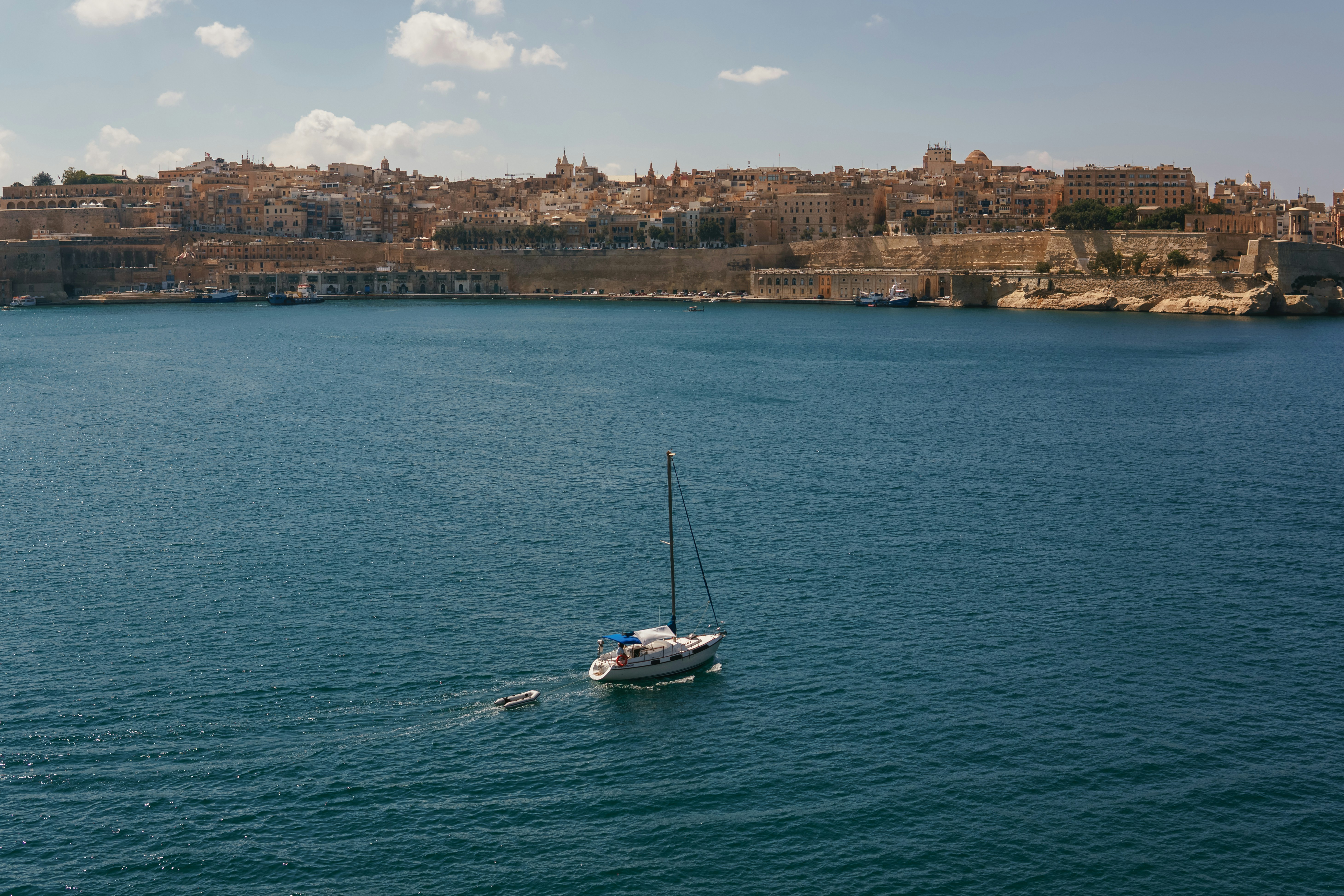 woman wearing yellow long-sleeved dress under white clouds and blue sky during daytime