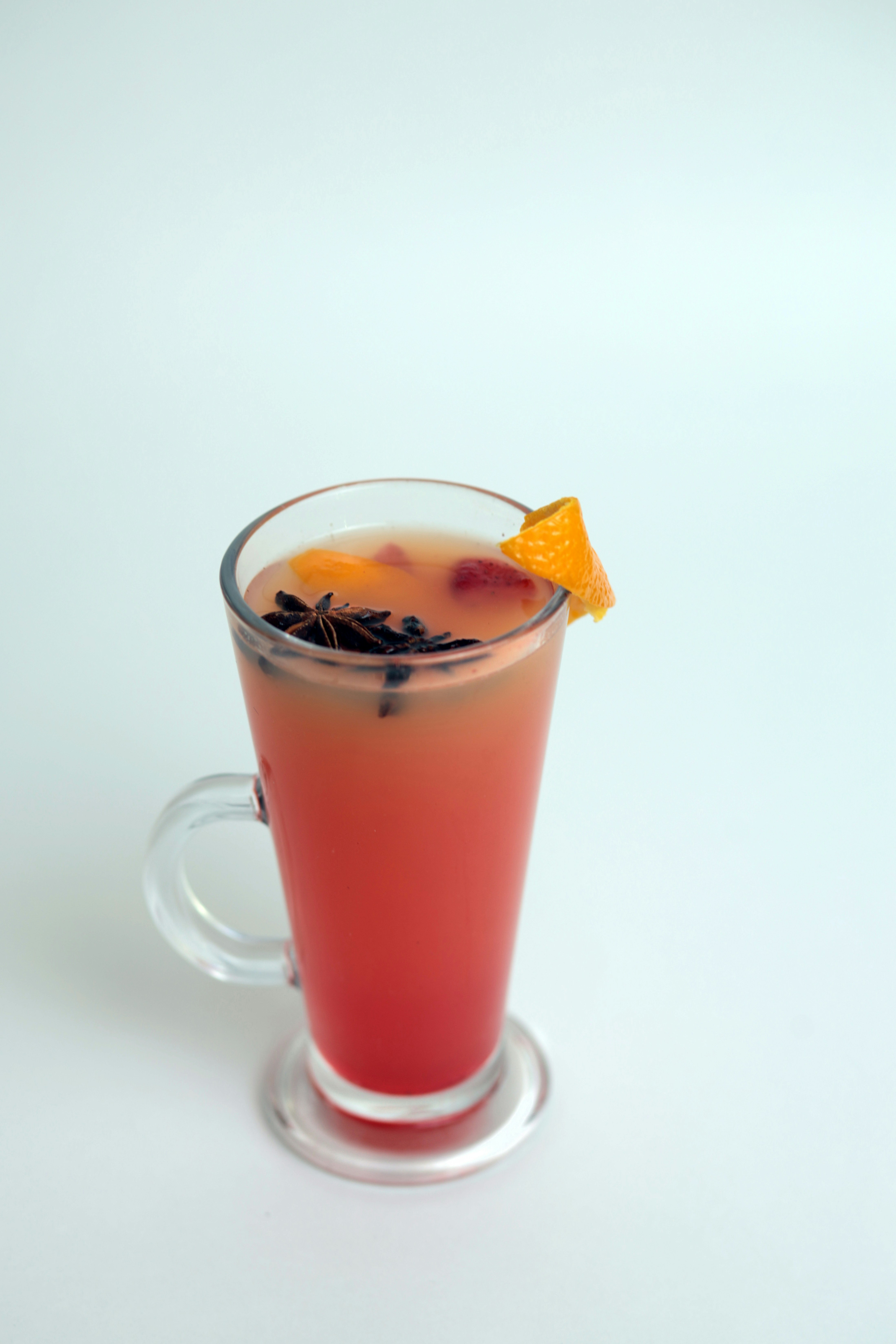 A drink with a slice of orange on top of it