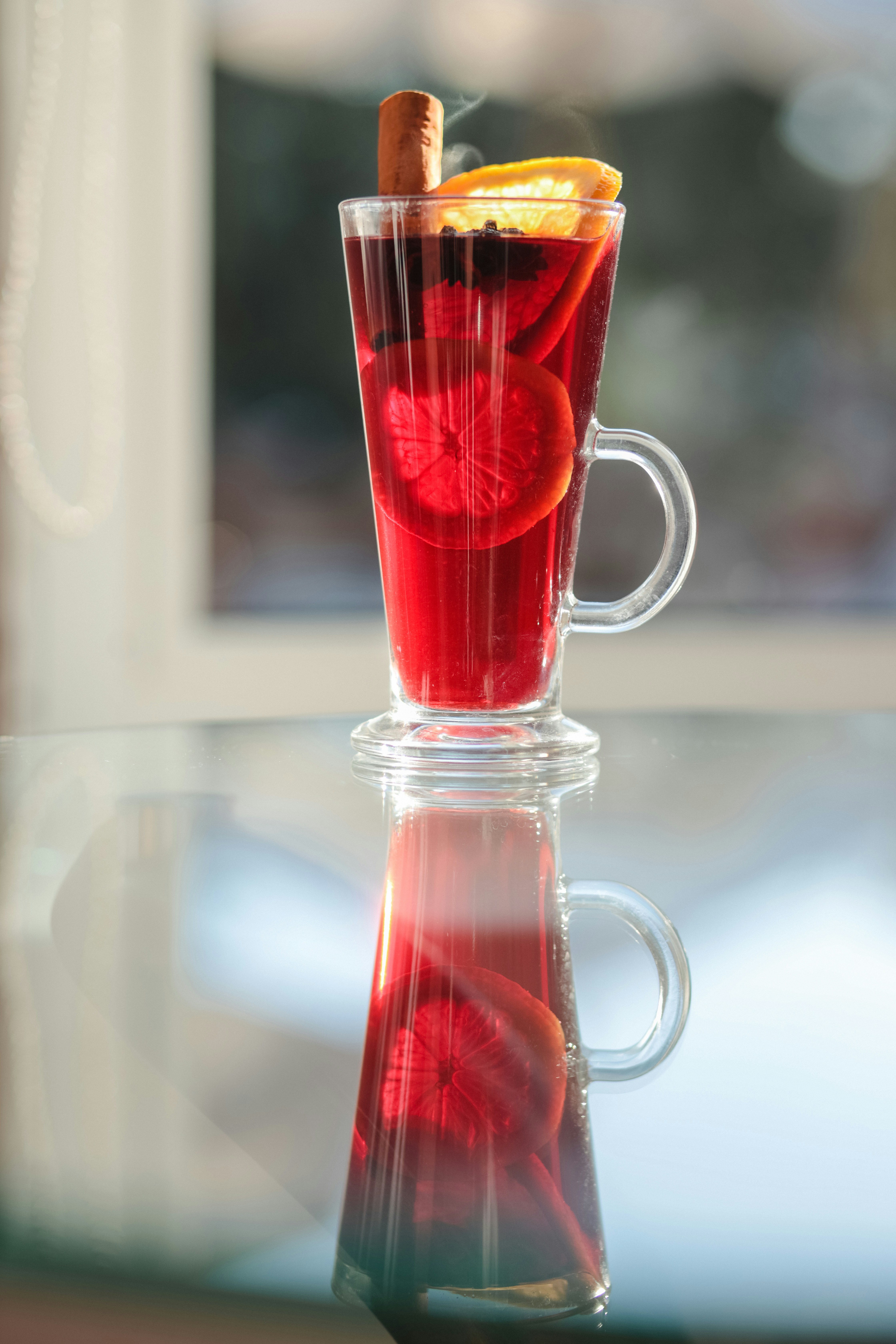 A glass cup filled with liquid and a cigar