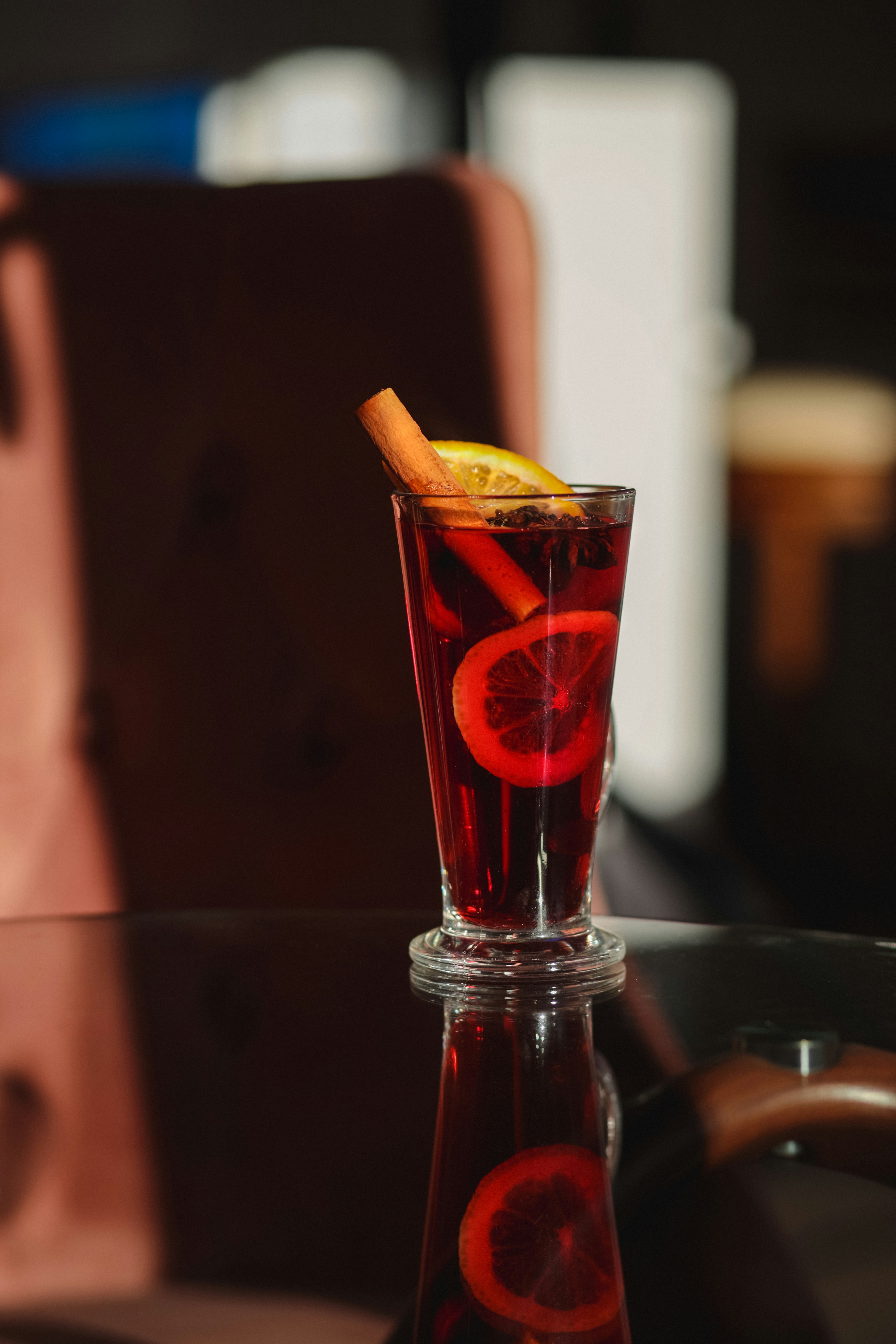 A glass with a drink and a slice of orange