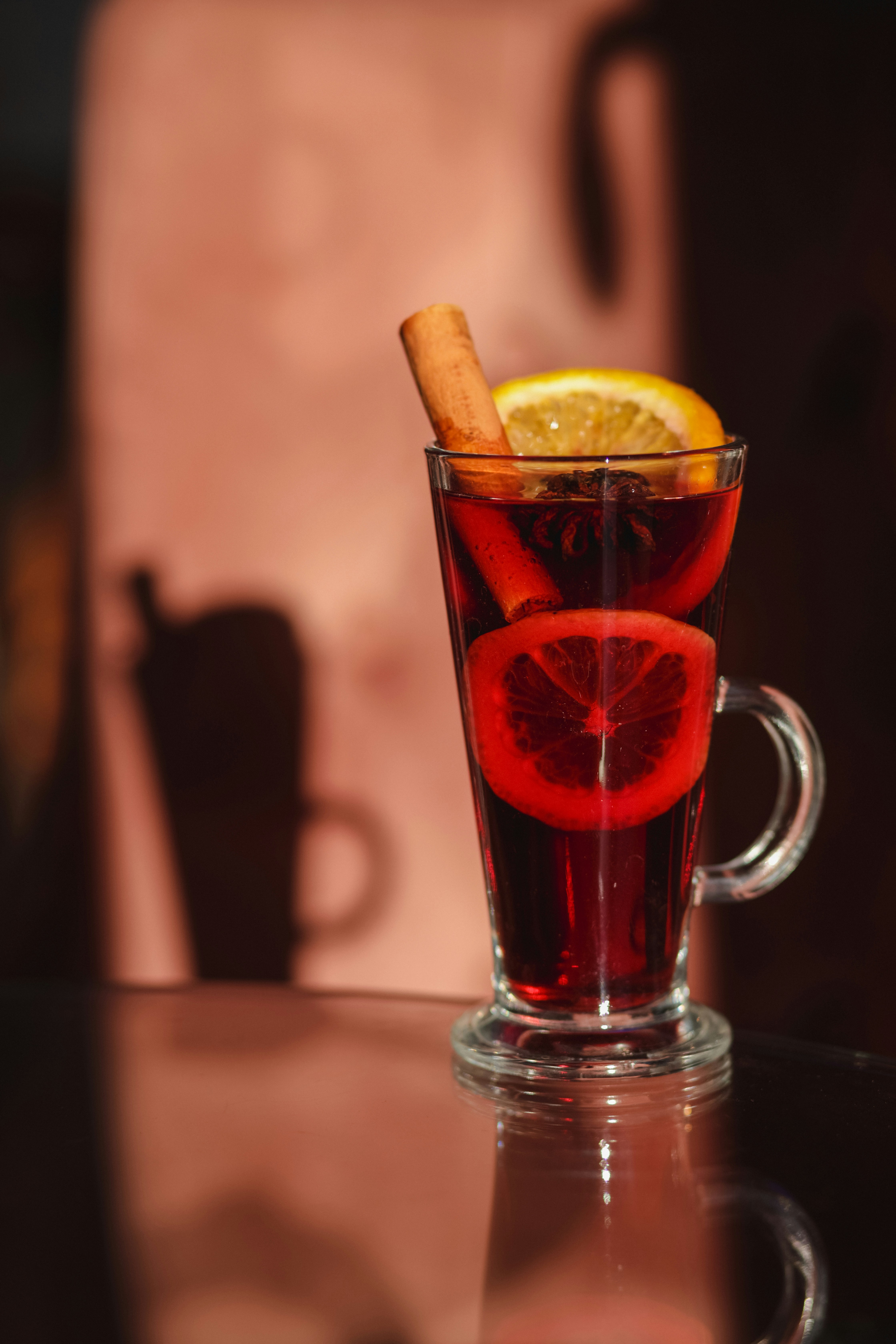 A glass of tea with a cinnamon stick in it