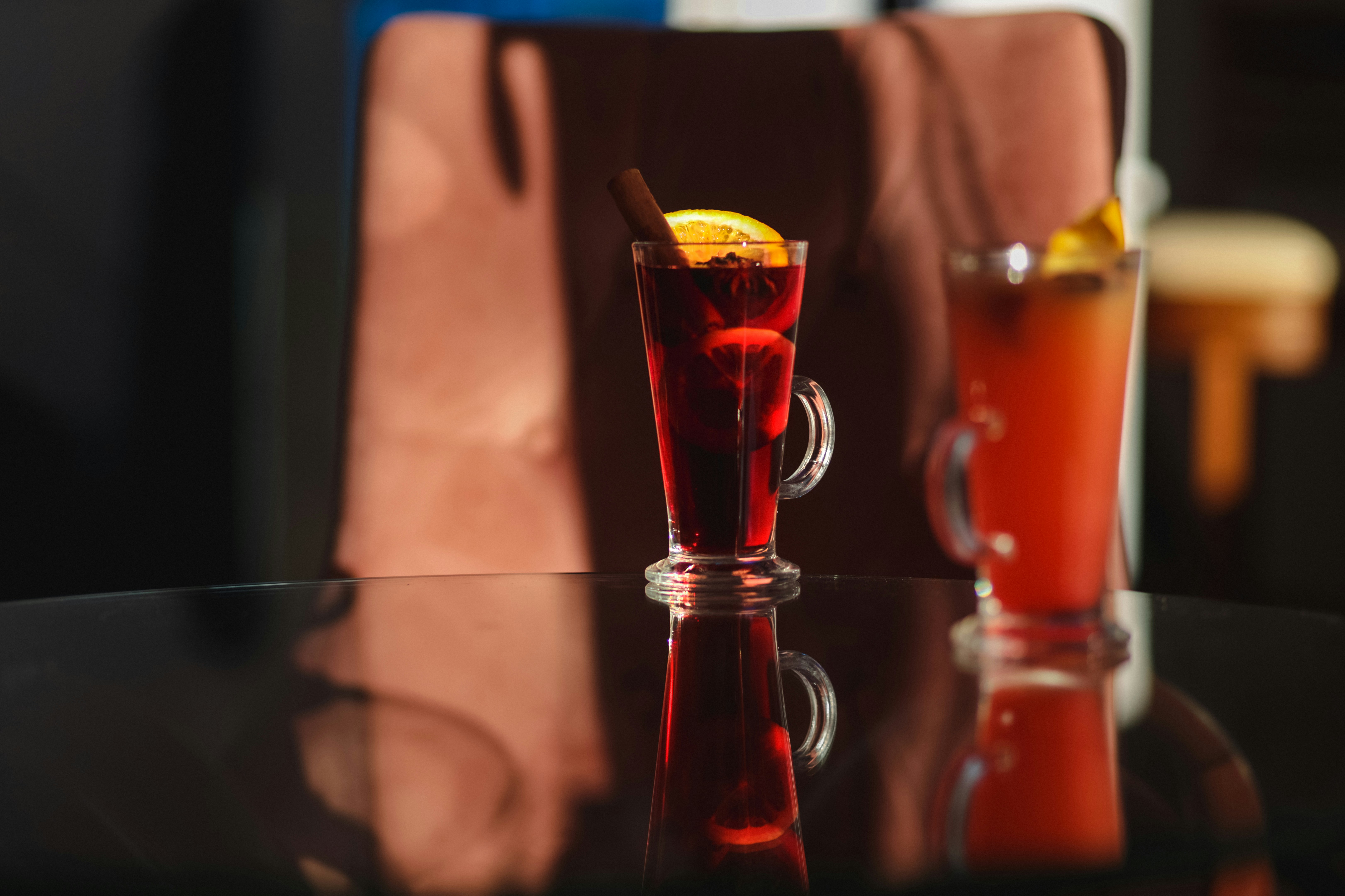 Two glasses of drinks sitting on a table