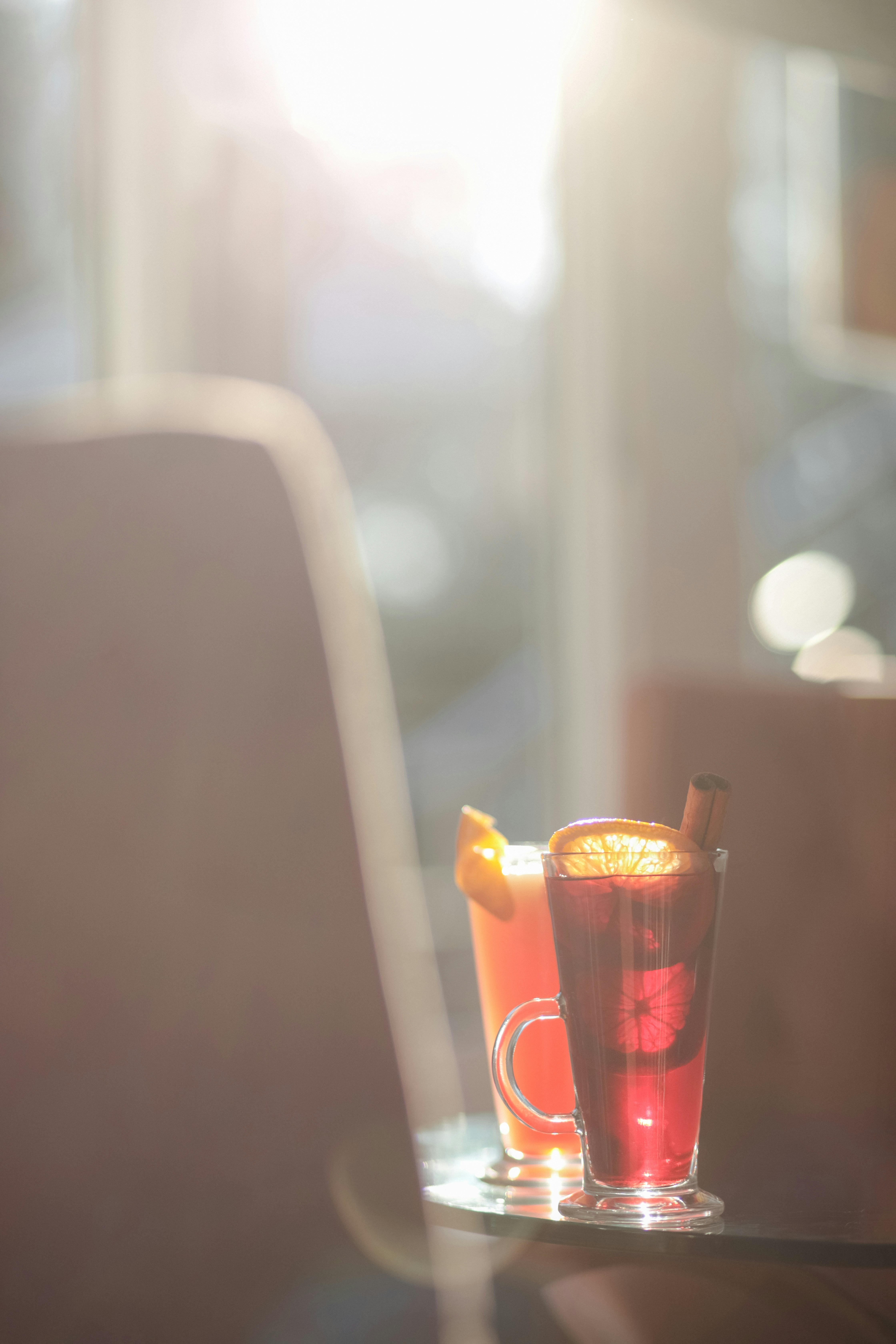 A table with a drink and a laptop on it