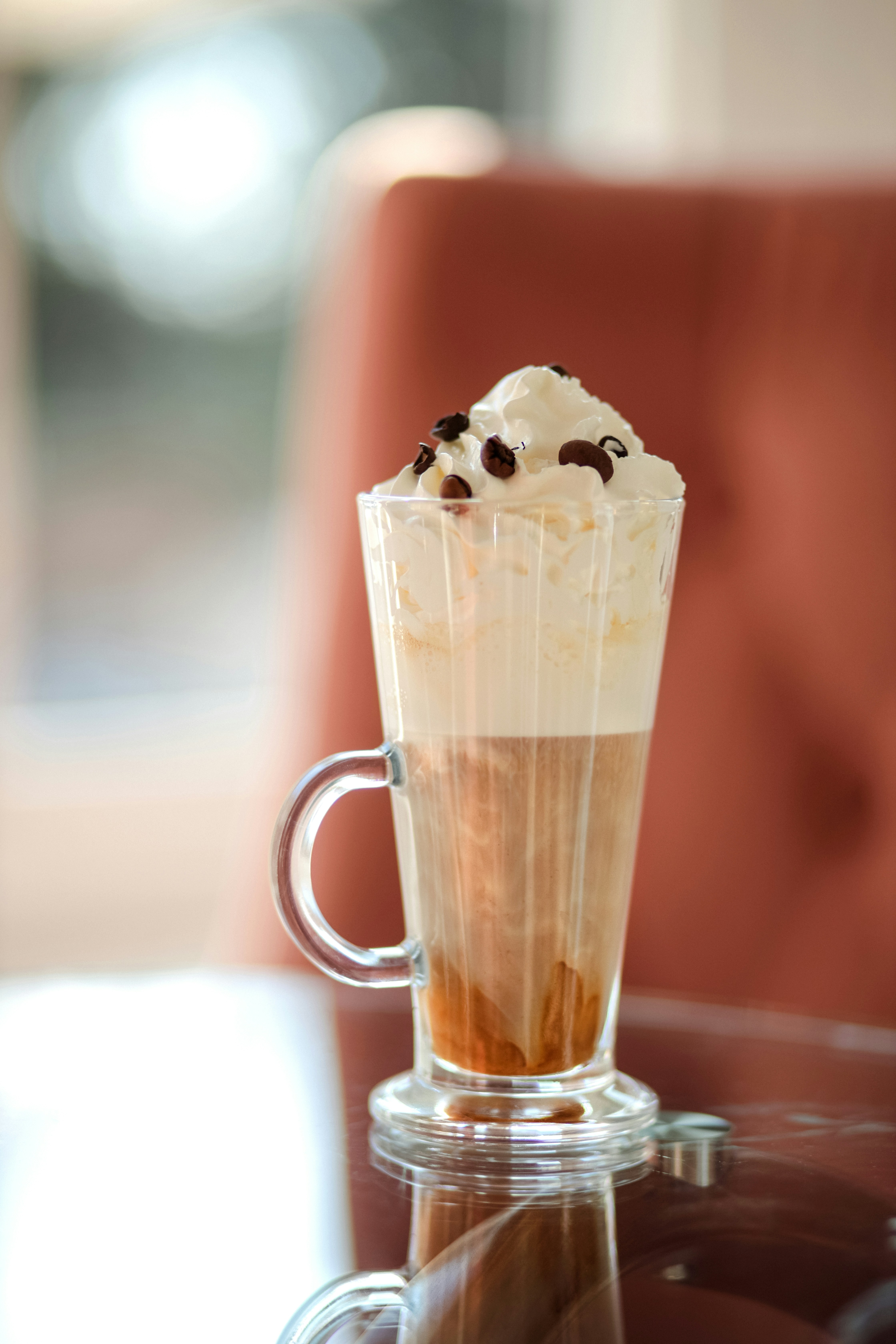 A cup of coffee sitting on top of a glass table