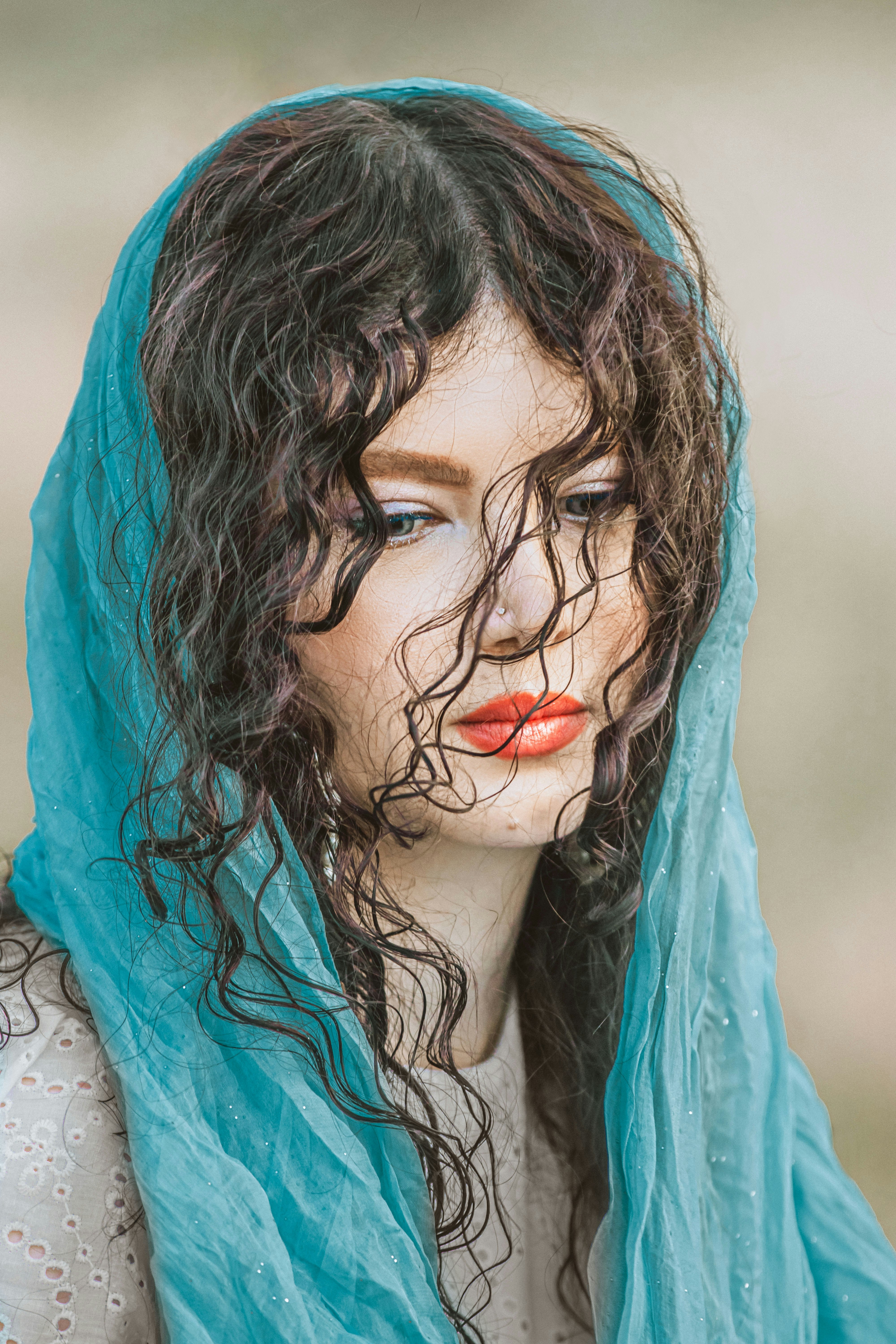 A woman with a blue scarf around her head