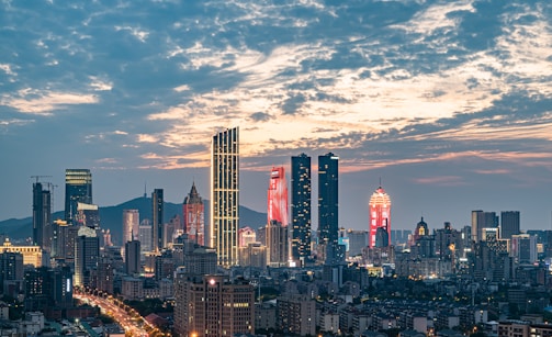 A view of a city at night from the top of a hill