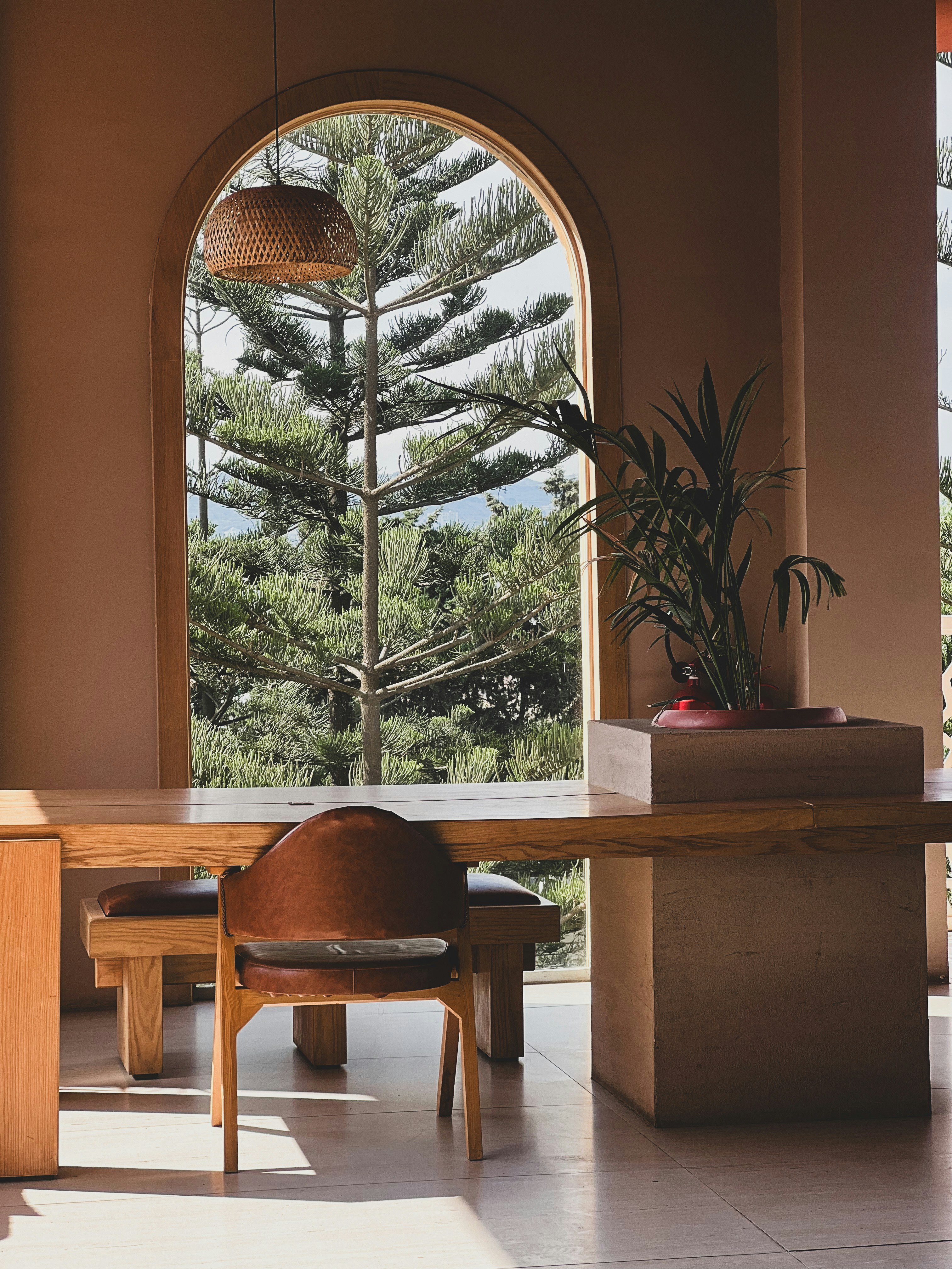 A room with a table and chairs and a large window