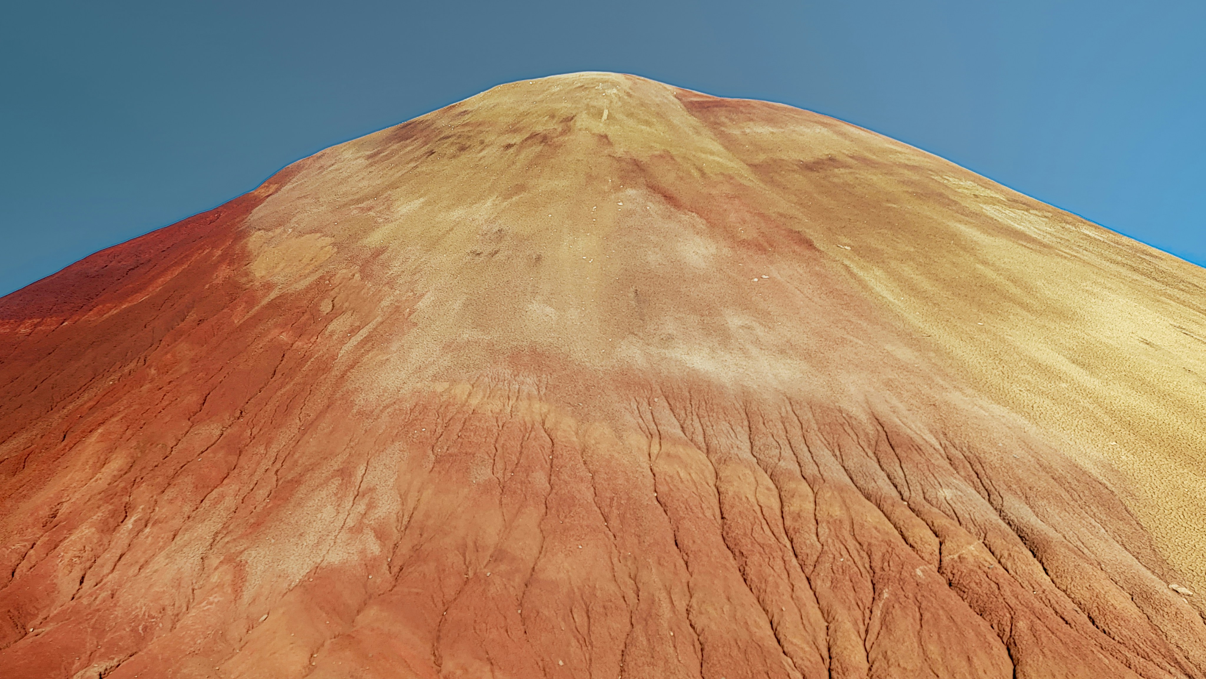 A very large mountain with a sky in the background, 