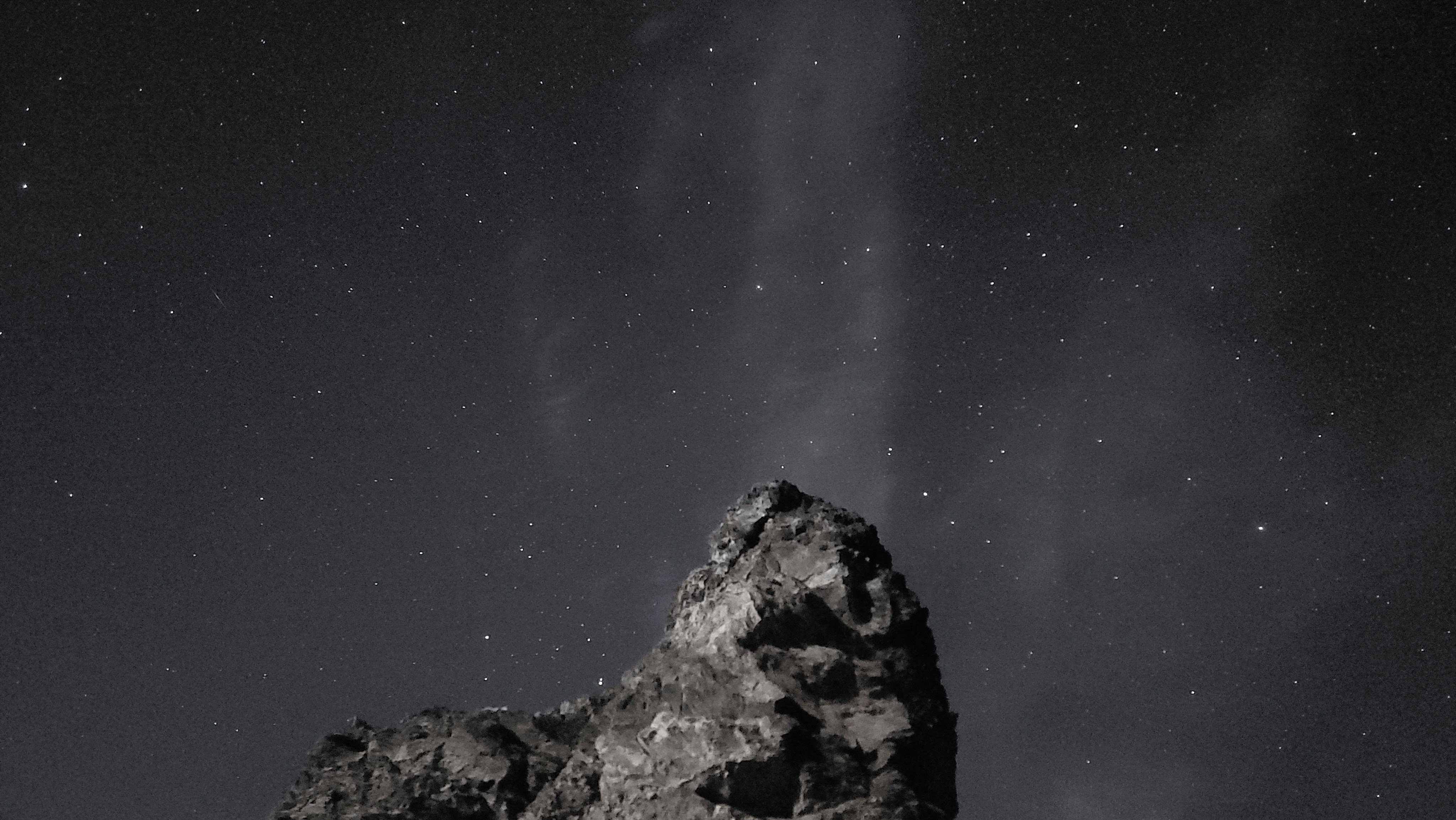 A large rock in the middle of a night sky