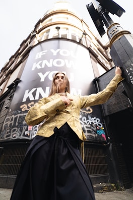 A woman standing in front of a tall building