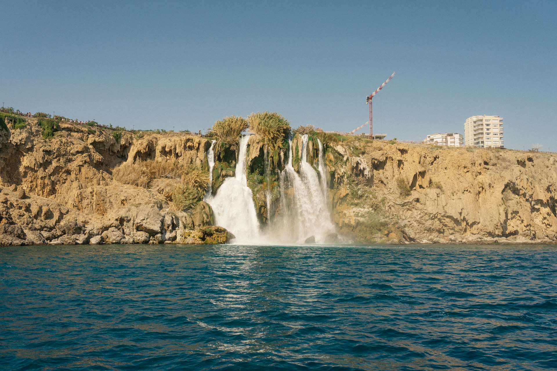 A waterfall in the middle of a body of water