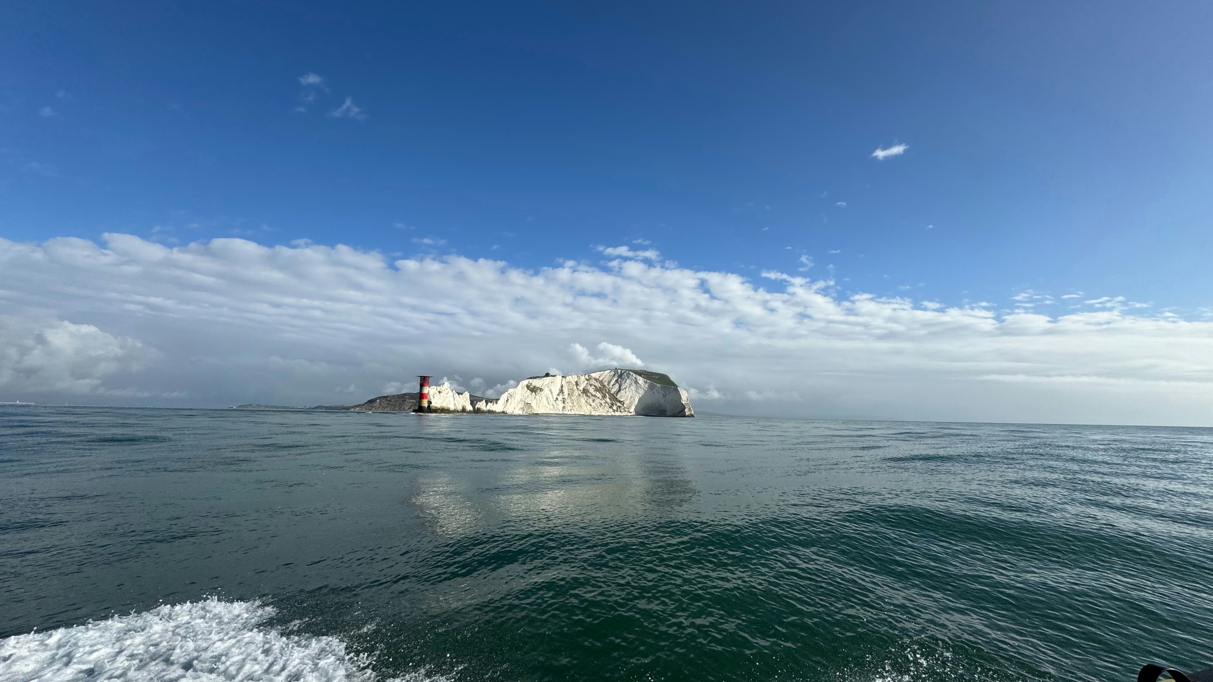 A large body of water with a small island in the distance