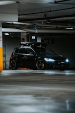 A black car parked in a parking garage