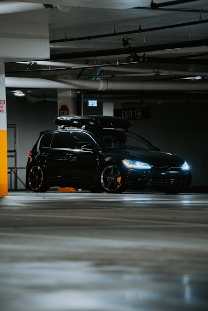 A black car parked in a parking garage