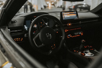 The interior of a car with the dashboard lights on