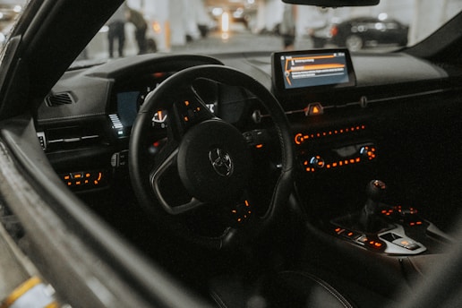 The interior of a car with the dashboard lights on