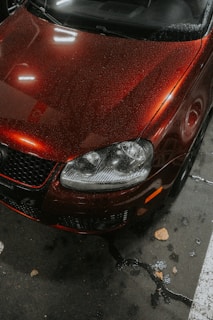 A red car parked in a parking space