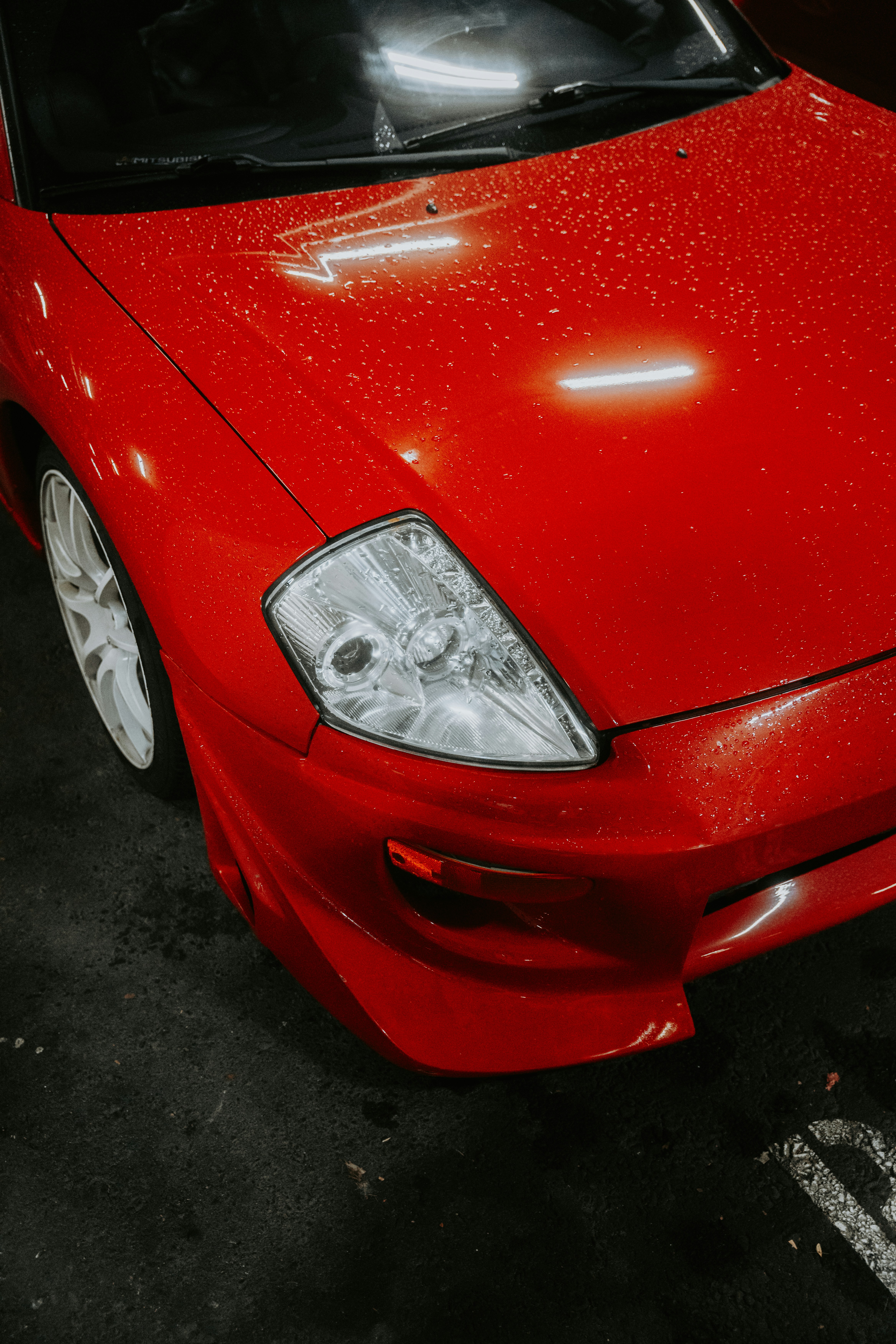 A red car parked in a parking lot photo – Free Car Image on Unsplash