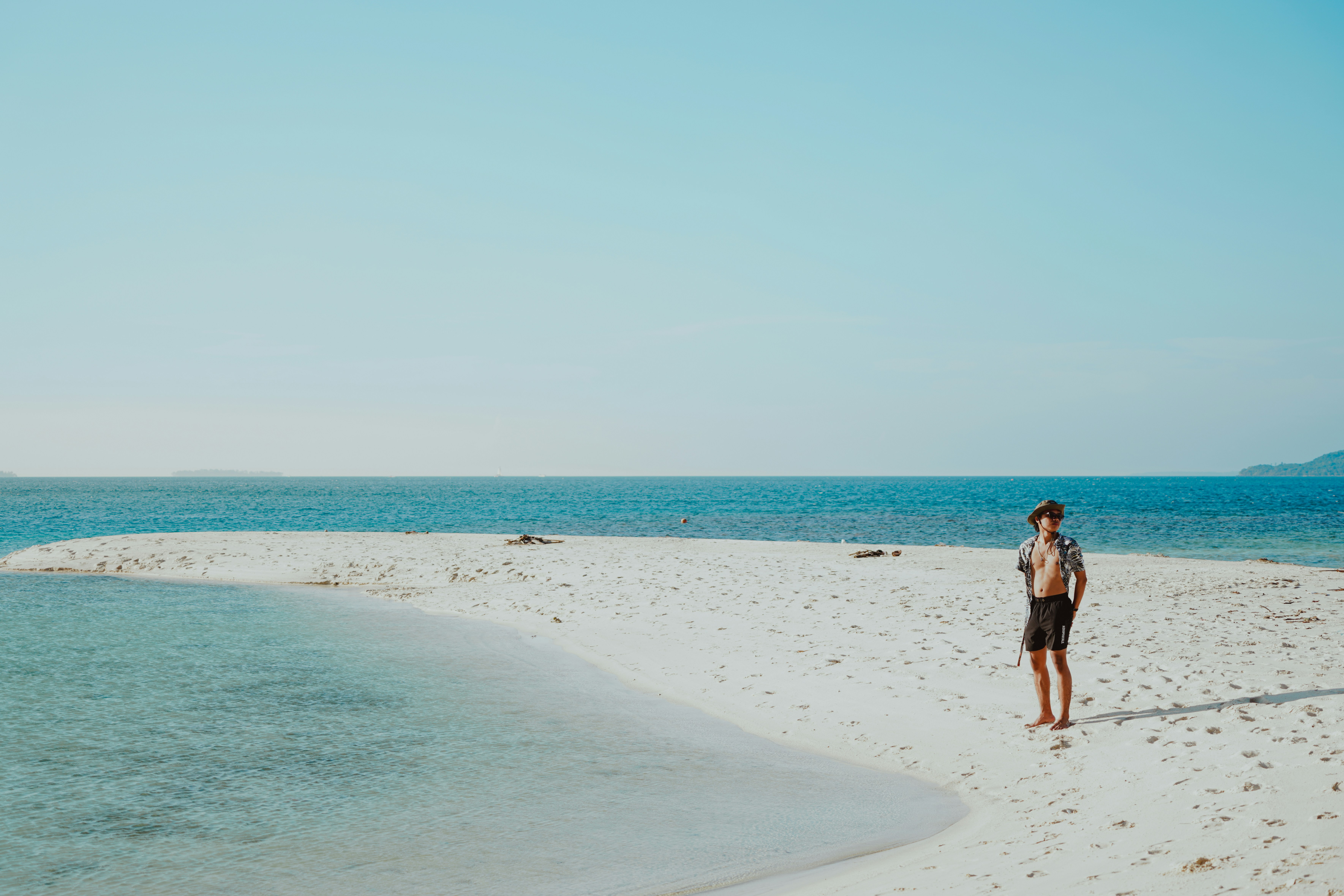 A person walking on a beach near the ocean, Relaxing Walk by the Ocean’s Edge
