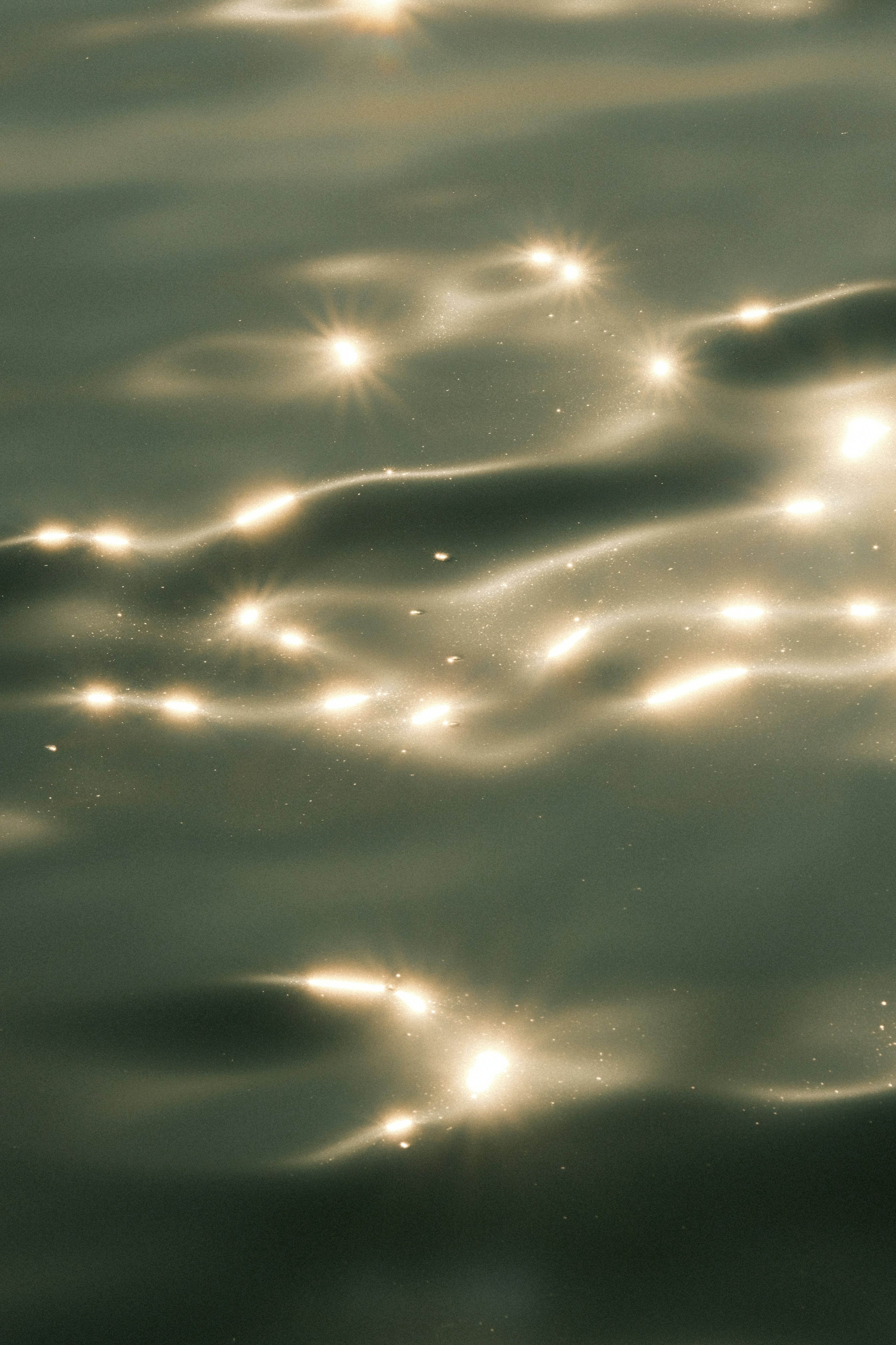 The sun shines brightly on the water surface