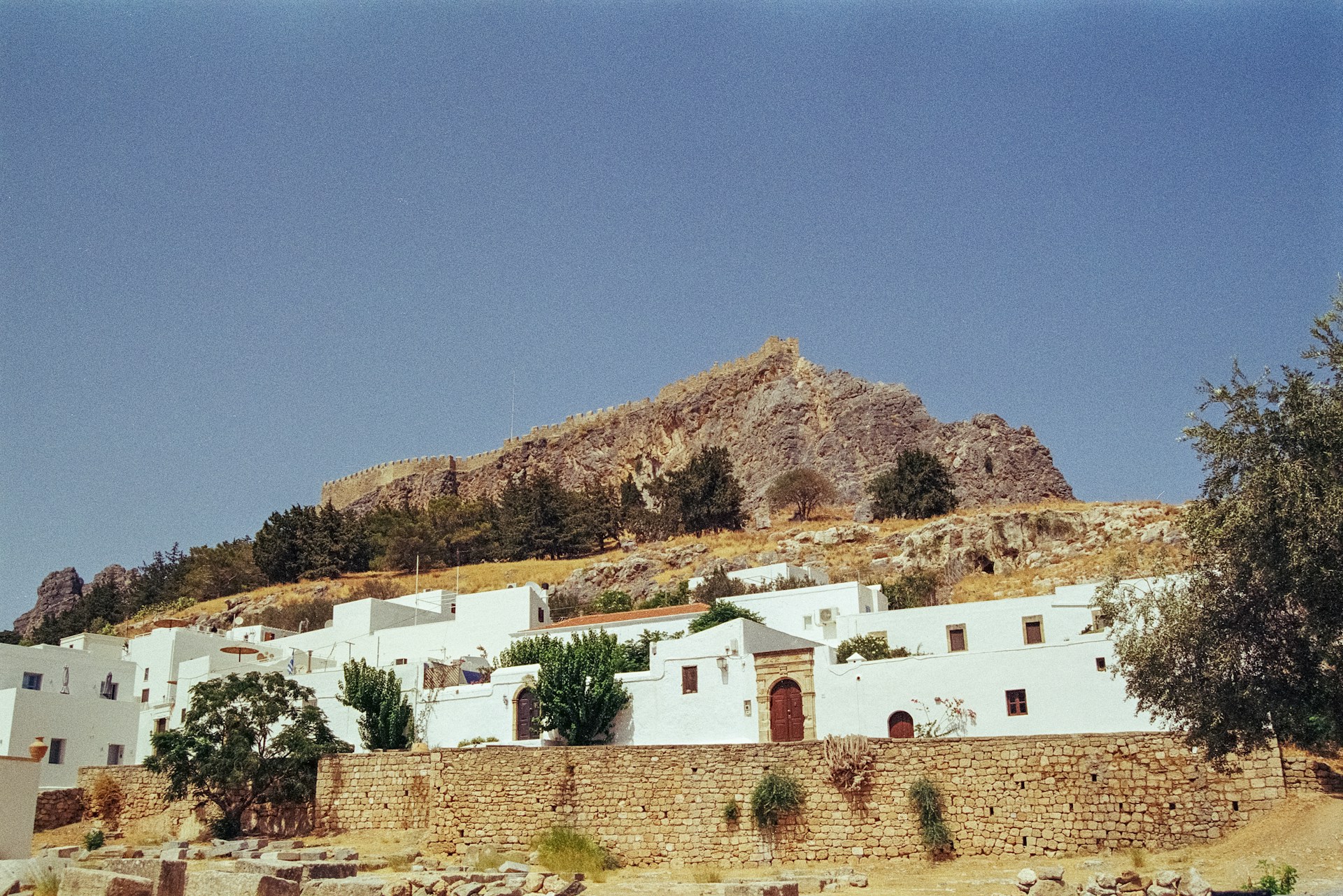 A white building with a mountain in the background