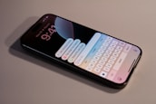 A close up of a cell phone with a keyboard on it