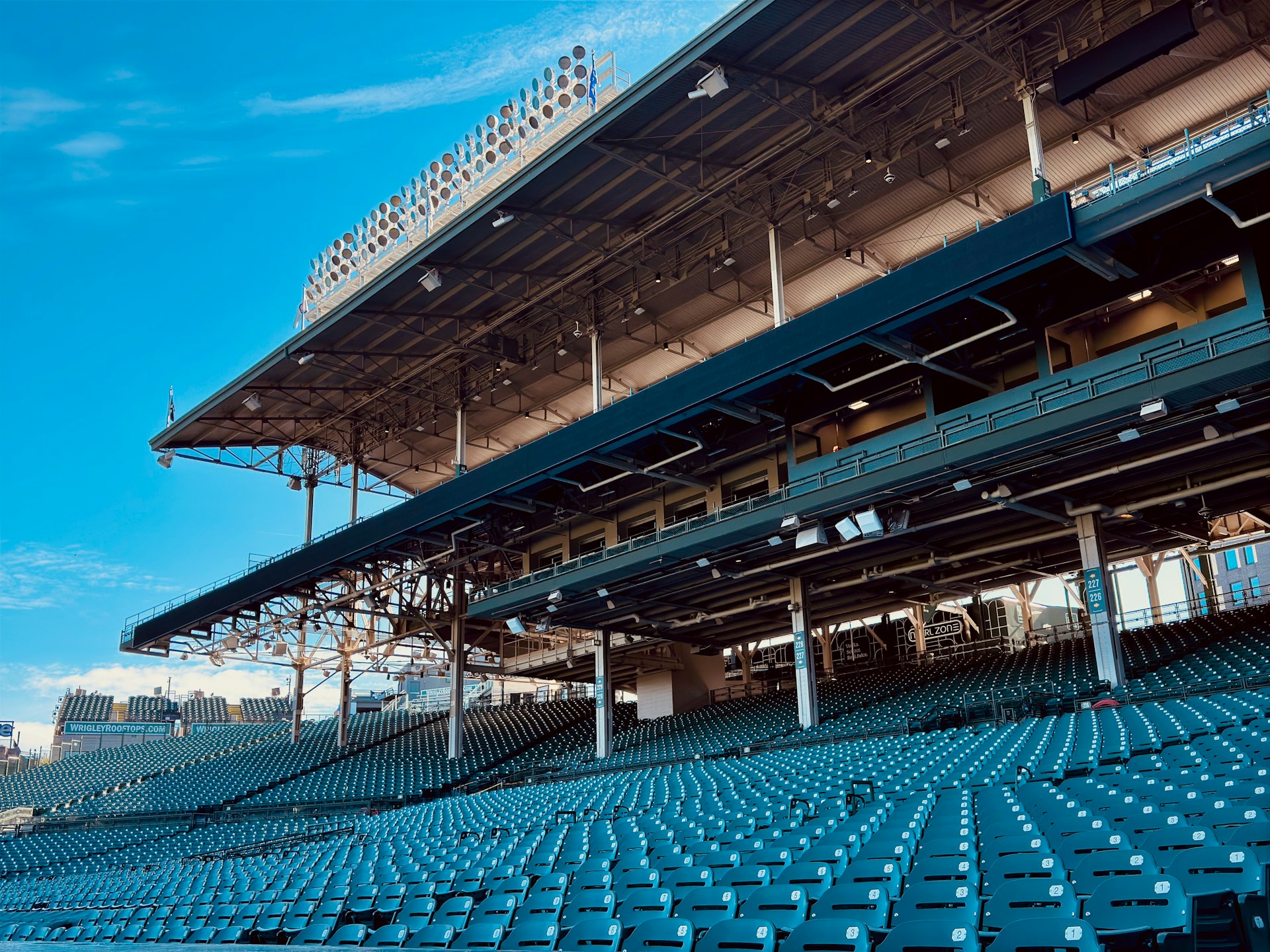 An empty stadium with a blue sky in the background