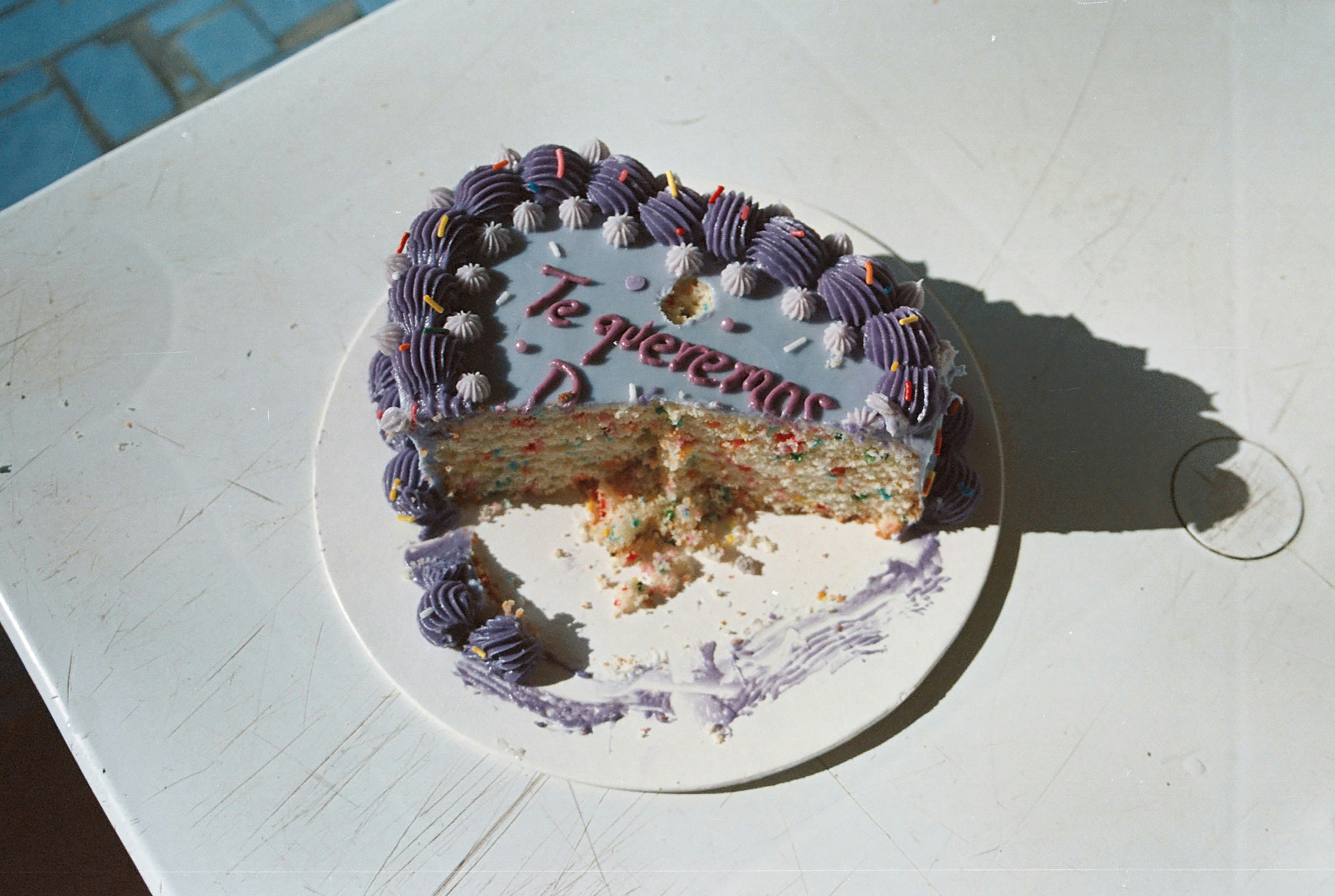 A half eaten cake sitting on top of a table