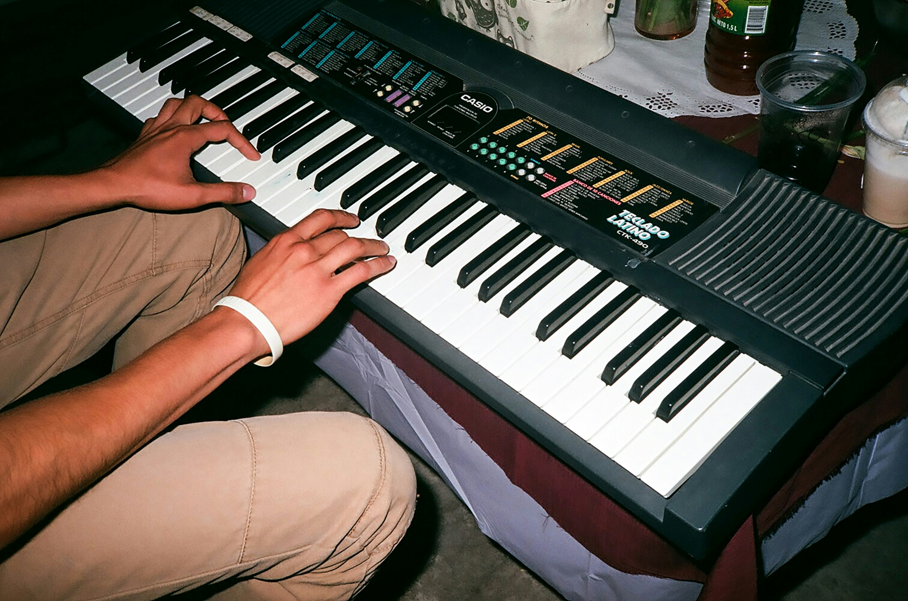 A man sitting in front of an electronic keyboard