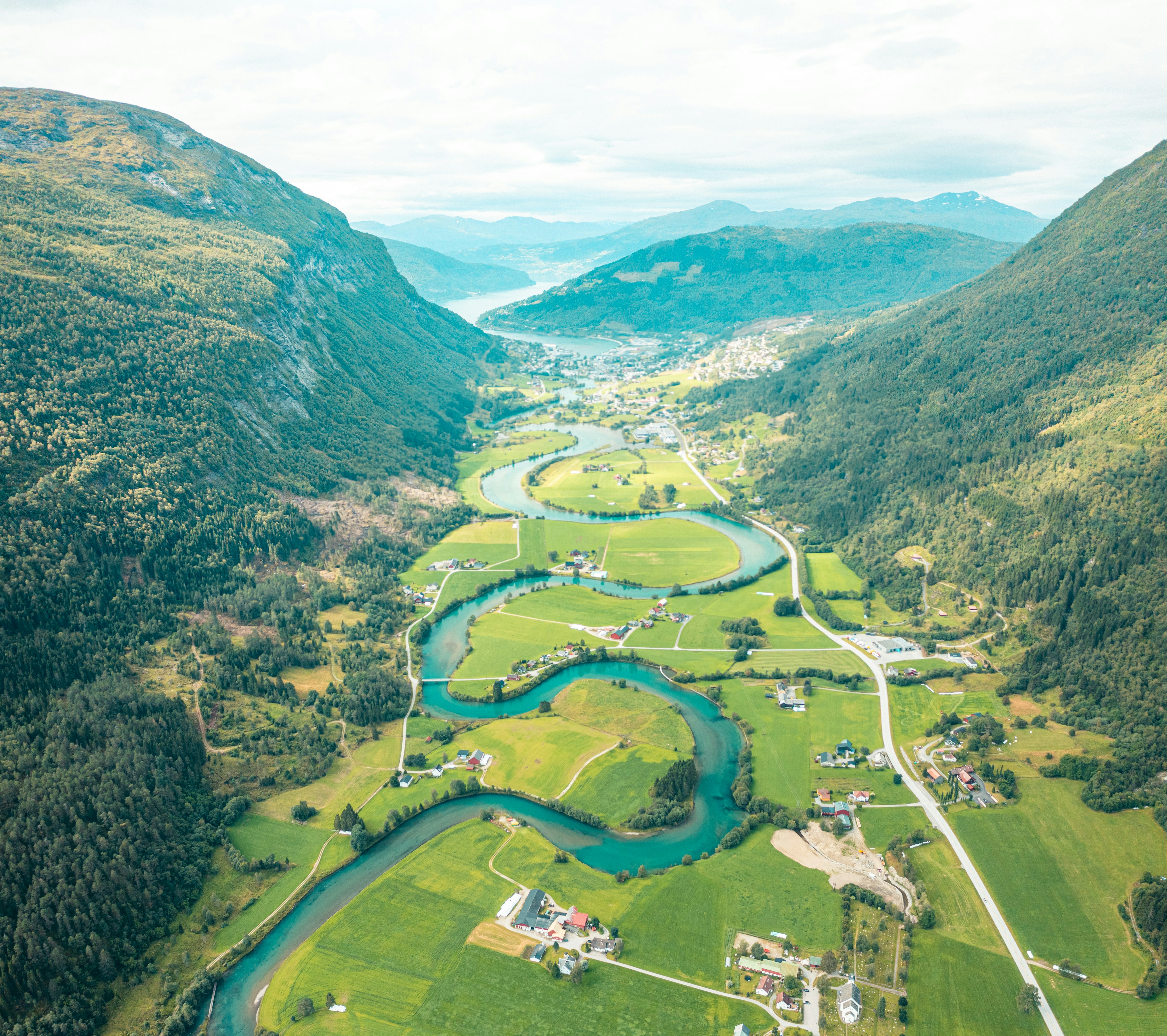 A river running through a lush green valley