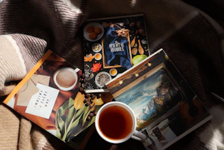 A cup of tea and some books on a blanket