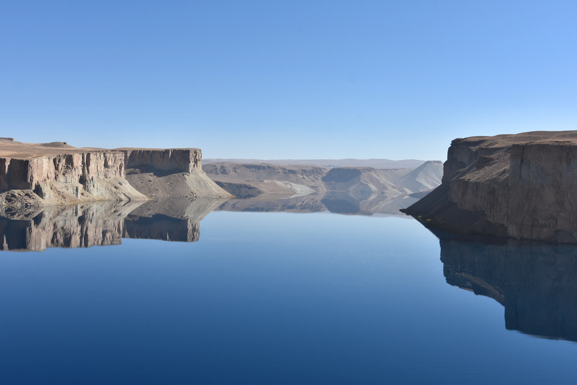 A large body of water surrounded by mountains