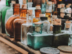 A table topped with lots of bottles filled with liquid