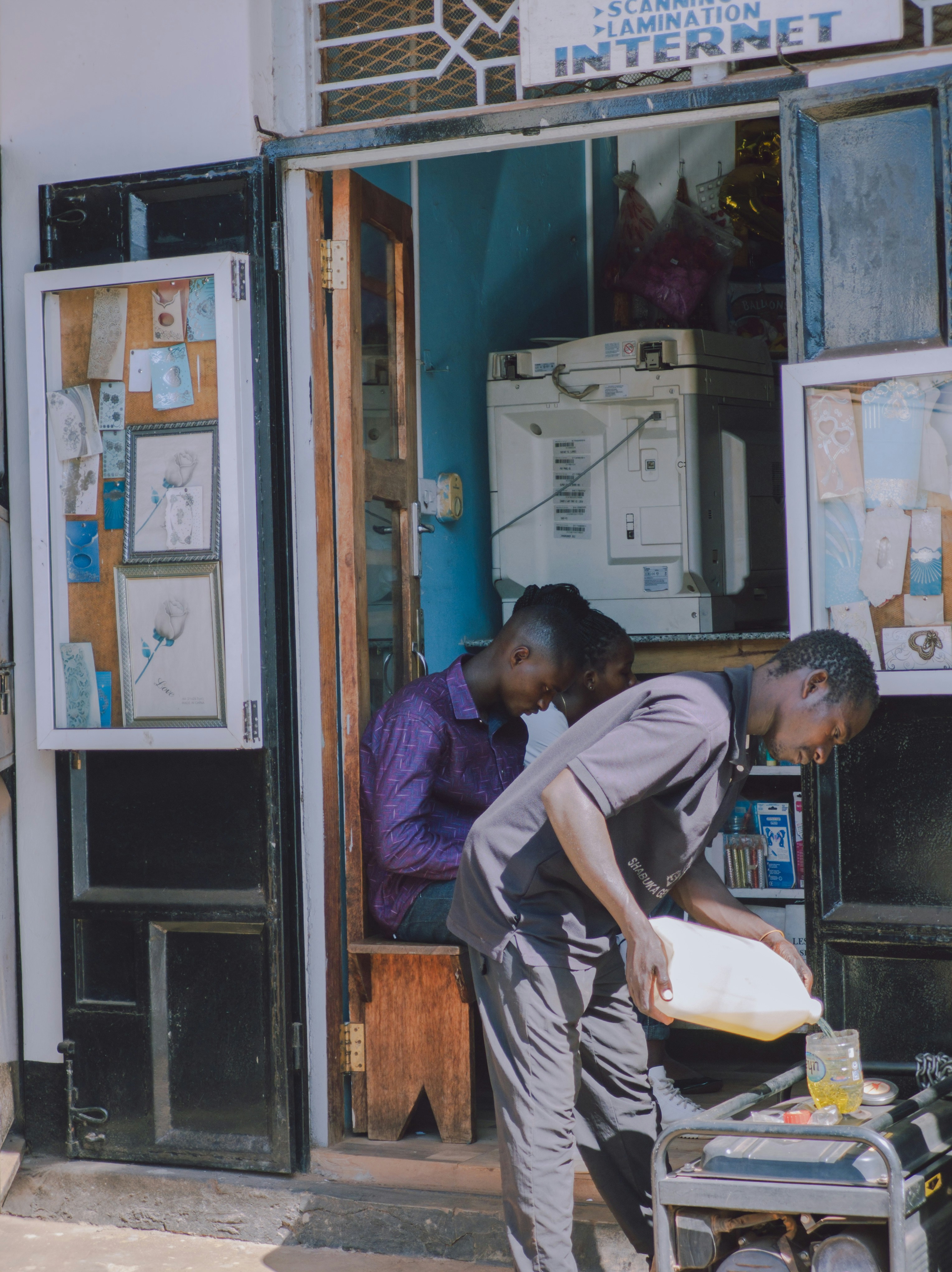 A couple of men standing in front of a store