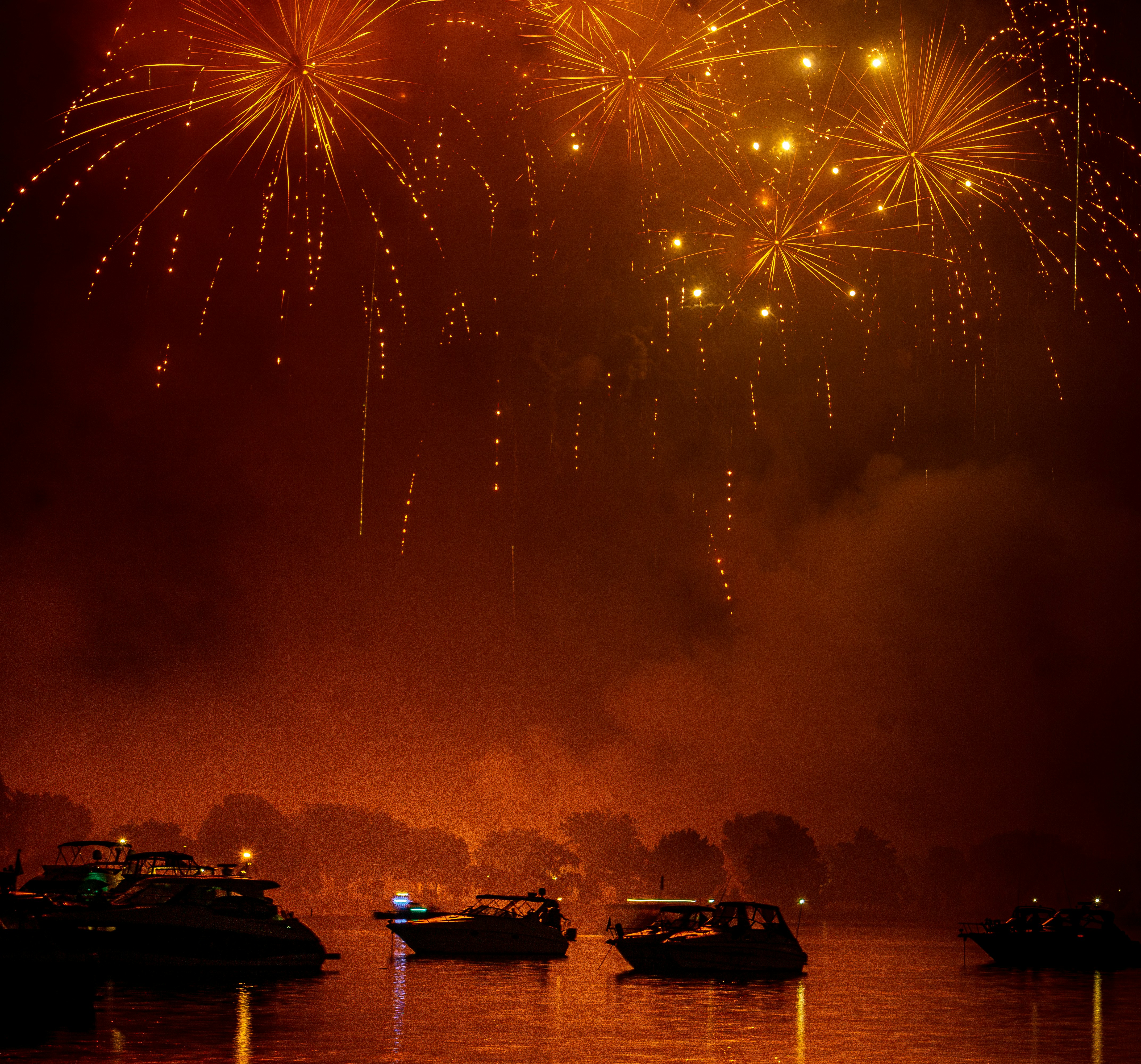A fireworks display over a body of water