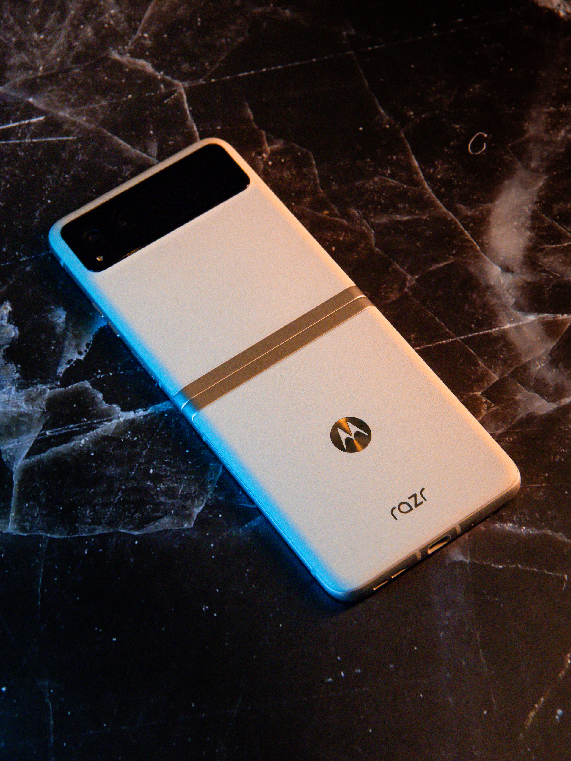 A white cell phone sitting on top of a table