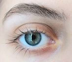 A close up of a person's blue eye