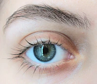 A close up of a person's blue eye