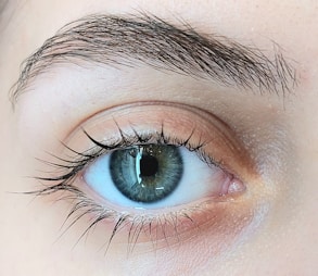 A close up of a person's blue eye