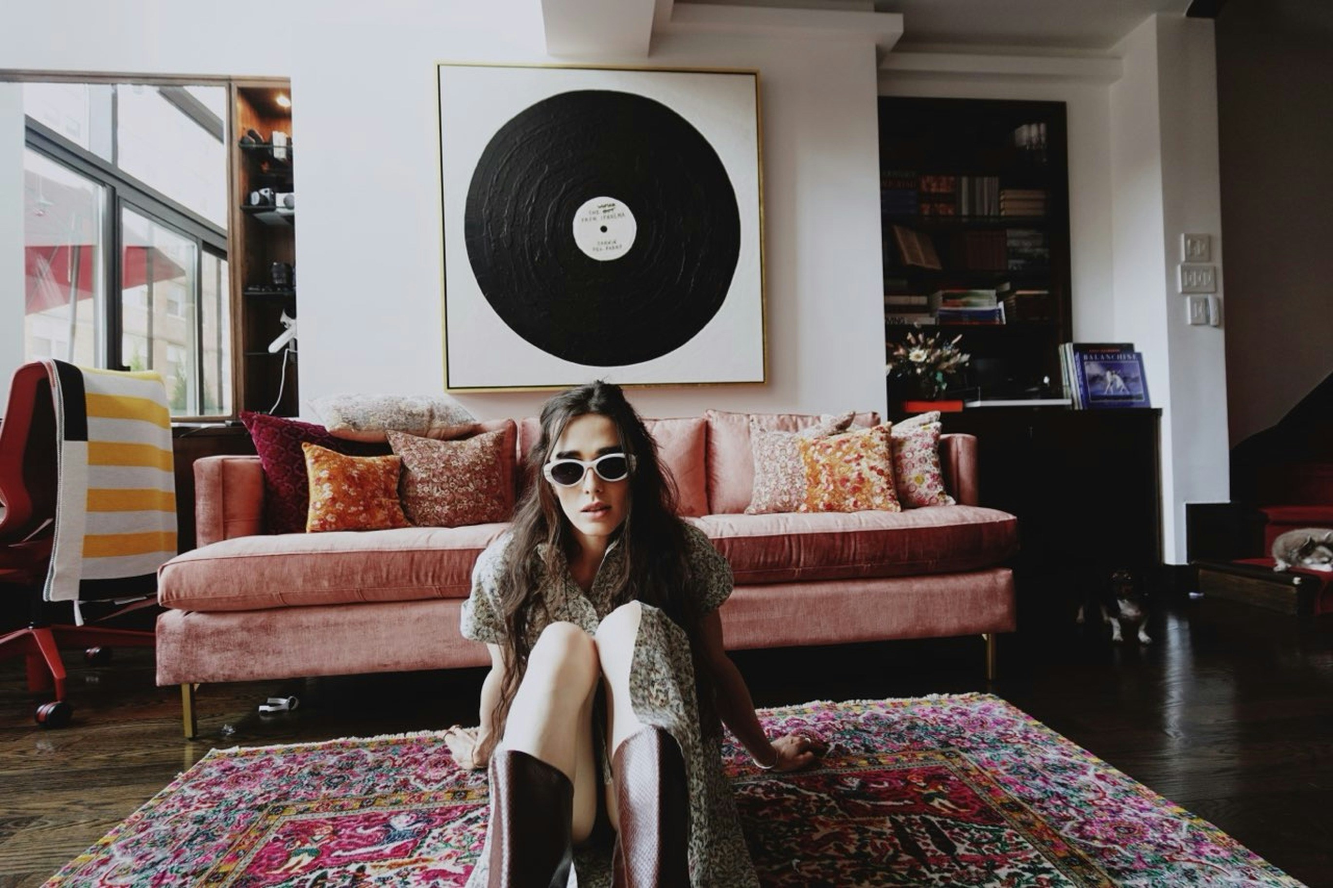 A woman sitting on a rug in a living room photo – Free Darwin Image on ...