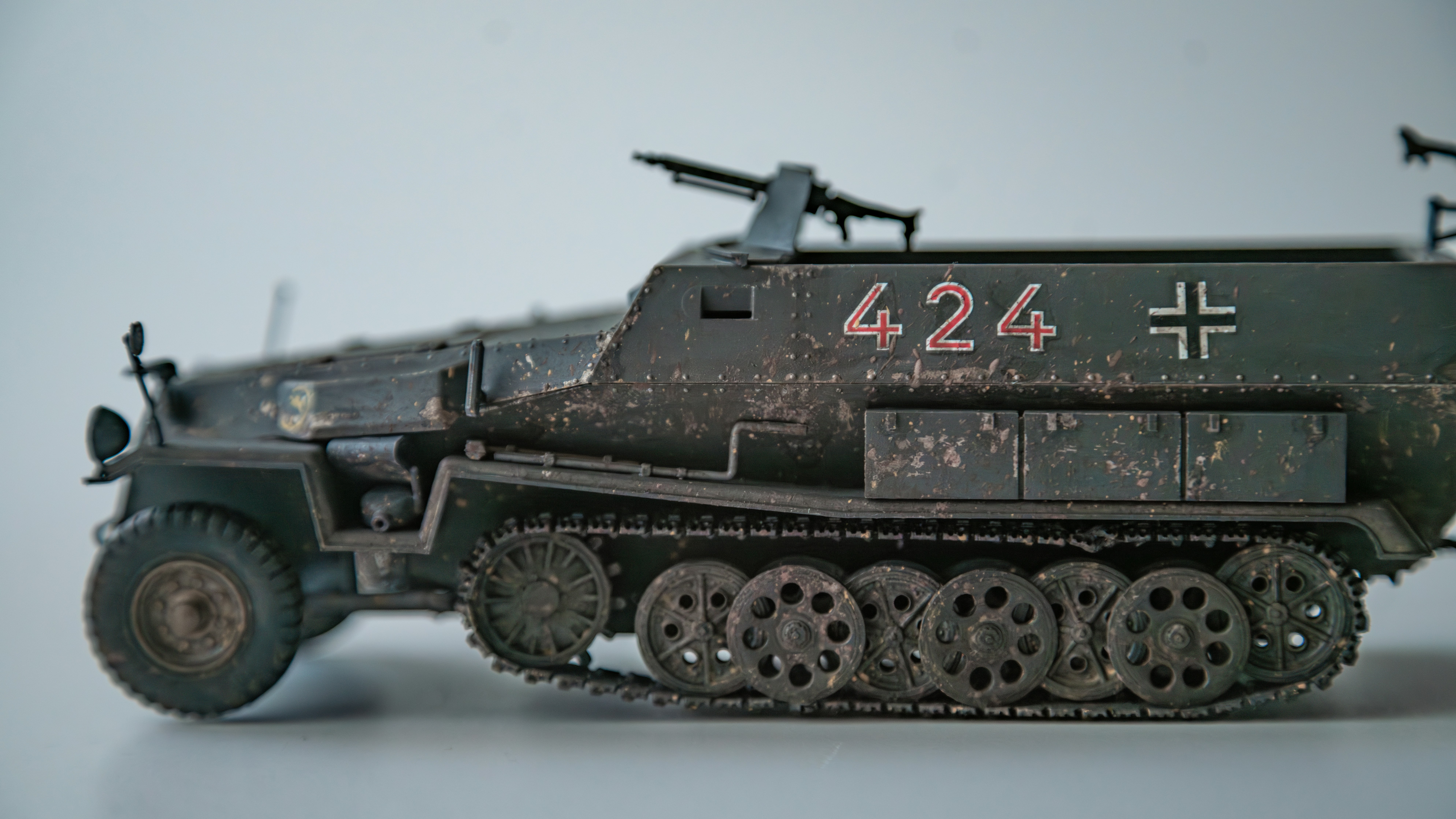 A toy army tank with a cross on the side