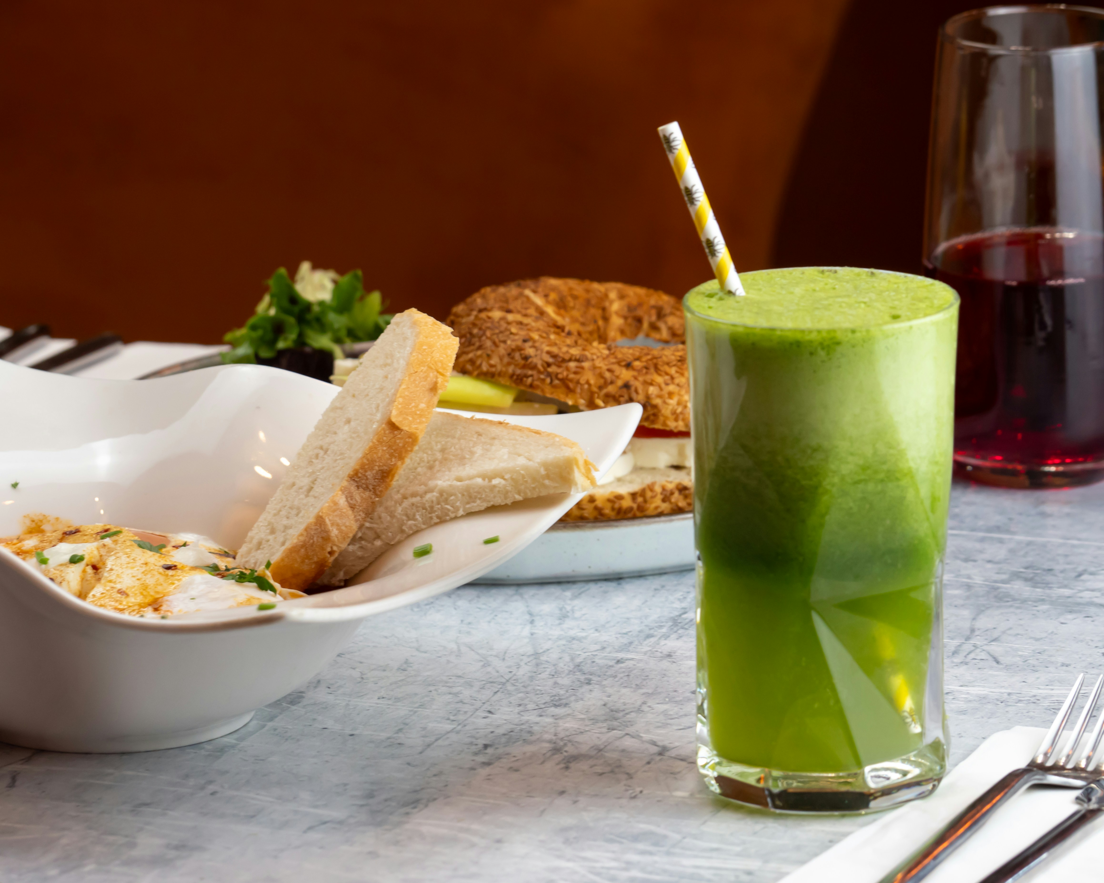 Celery Juice In A Glass With Fresh Celery Stalks And A Peanut Butter Dip On A Wooden Table
