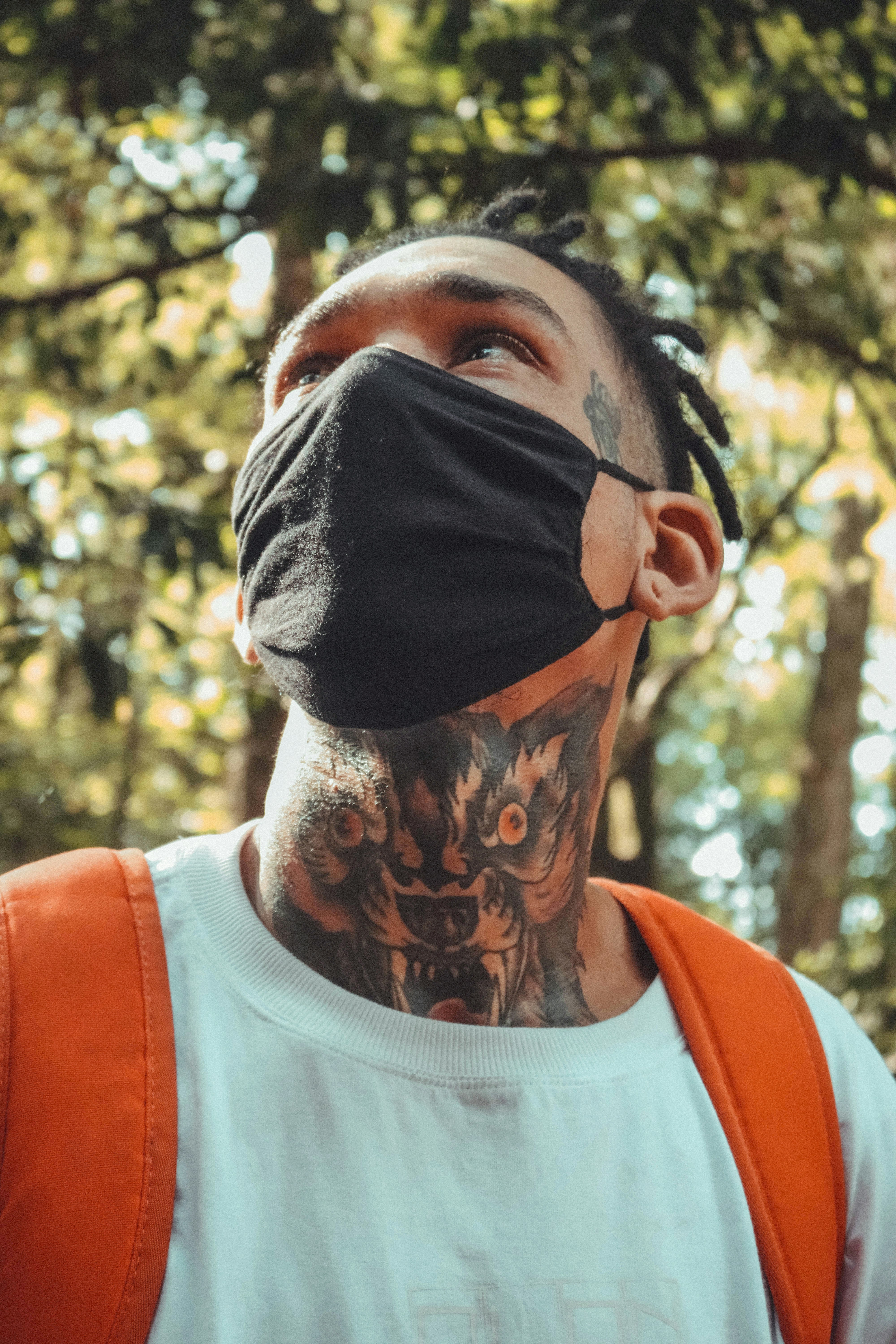 A man wearing a face mask in the woods