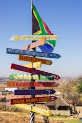 A pole with a bunch of signs on it