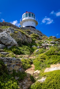 A lighthouse on top of a rocky hill