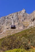 A cable car going up the side of a mountain