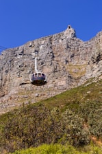 A cable car going up the side of a mountain