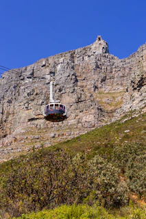 A cable car going up the side of a mountain
