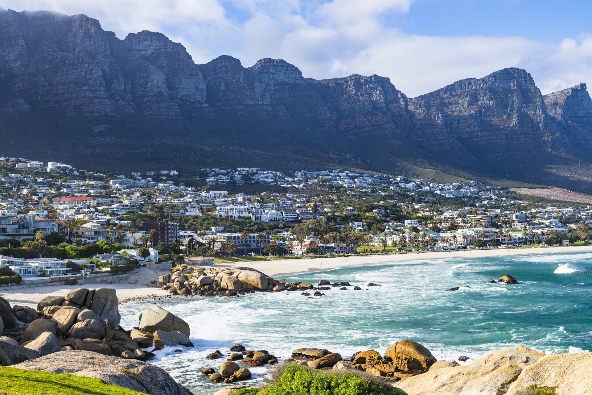A view of a beach with mountains in the background
